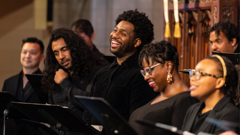 Several members of a choir singing joyously together